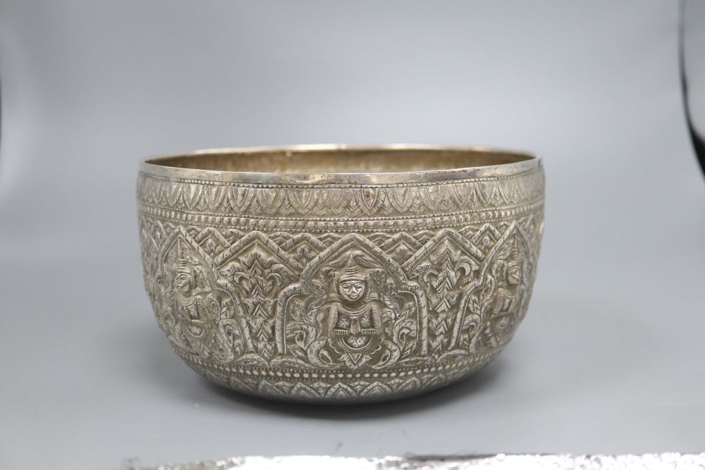 A Burmese silver bowl, c.1900, with repousse Buddha panels, 14.3oz., diameter 21cm